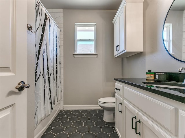 full bathroom featuring vanity, toilet, tile patterned flooring, and shower / bath combo