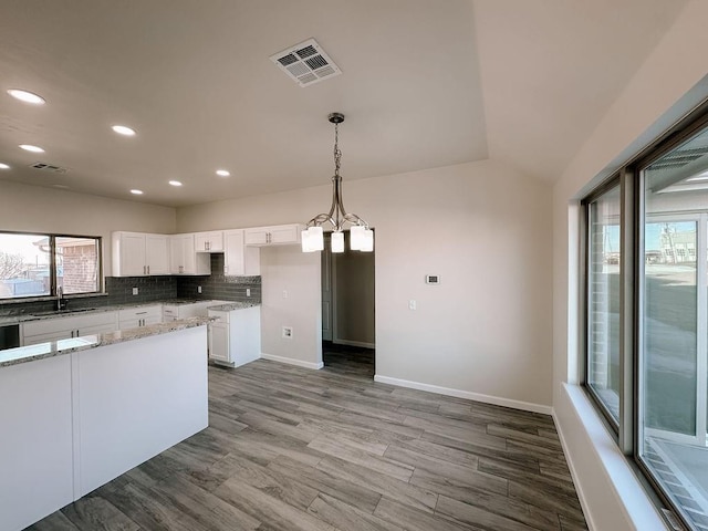210 S Noble Ave, Hinton, OK 73047 - kitchen with a sink, light stone counters, white cabinetry, recessed lighting, and backsplash