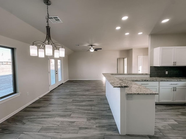 210 S Noble Ave, Hinton, OK 73047 - kitchen featuring white cabinetry, recessed lighting, baseboards, decorative backsplash, and light stone counters