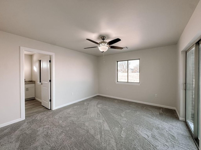210 S Noble Ave, Hinton, OK 73047 - unfurnished bedroom featuring carpet floors, baseboards, ceiling fan, and connected bathroom