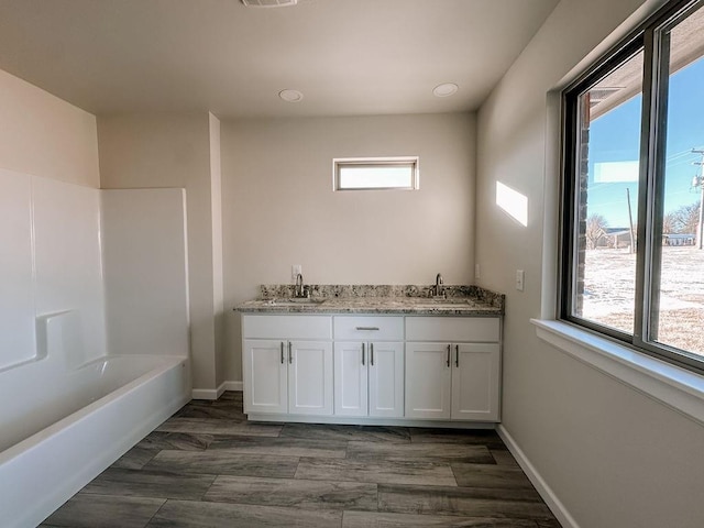 210 S Noble Ave, Hinton, OK 73047 - full bathroom featuring double vanity, baseboards, and shower / bathtub combination