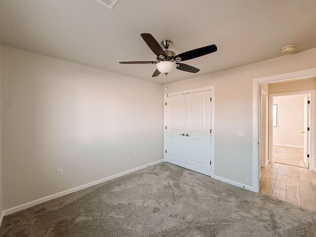 210 S Noble Ave, Hinton, OK 73047 - unfurnished bedroom featuring baseboards, a closet, carpet, and ceiling fan