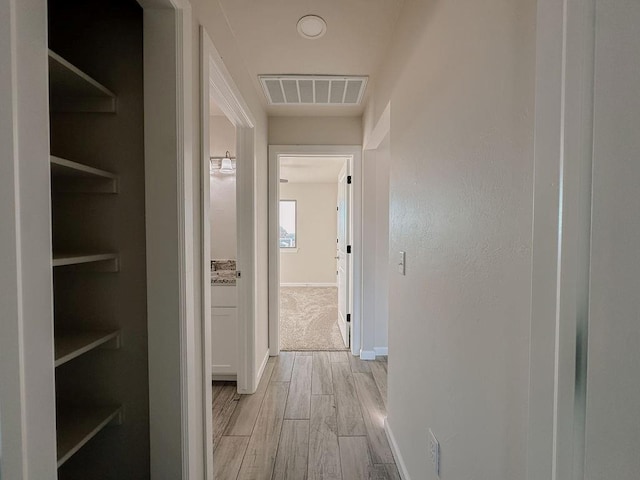 210 S Noble Ave, Hinton, OK 73047 - hallway with light wood-style flooring and baseboards