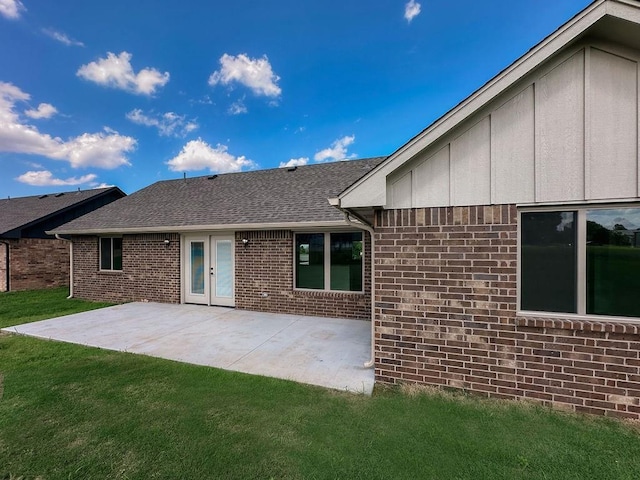 210 S Noble Ave, Hinton, OK 73047 - back of house featuring a lawn, a patio area, brick siding, and a shingled roof