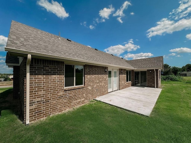 210 S Noble Ave, Hinton, OK 73047 - back of property with a patio, a lawn, roof with shingles, and brick siding