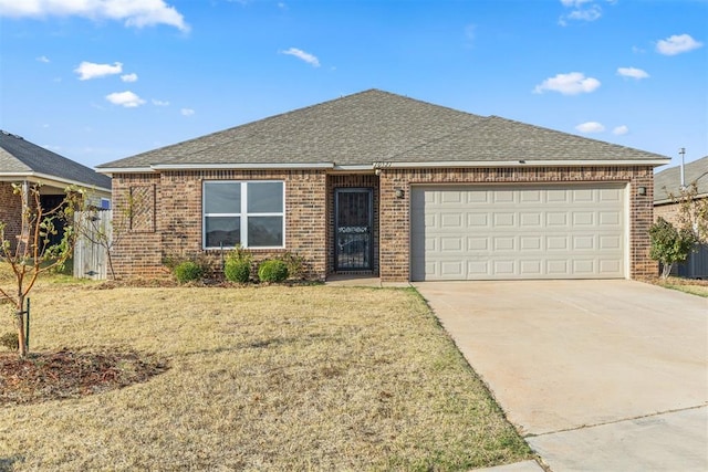 ranch-style house featuring a garage and a front yard