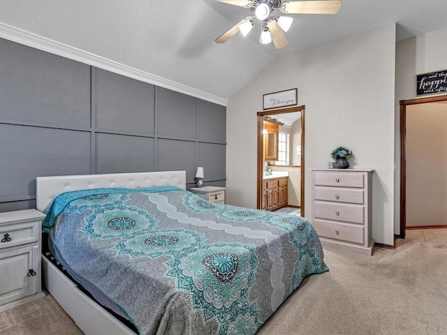 bedroom with light carpet, connected bathroom, vaulted ceiling, and ceiling fan