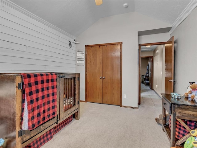 bedroom with lofted ceiling, crown molding, and light carpet