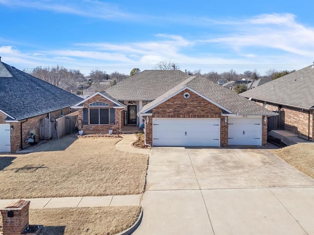 view of front of house featuring brick siding, roof with shingles, concrete driveway, fence, and a garage