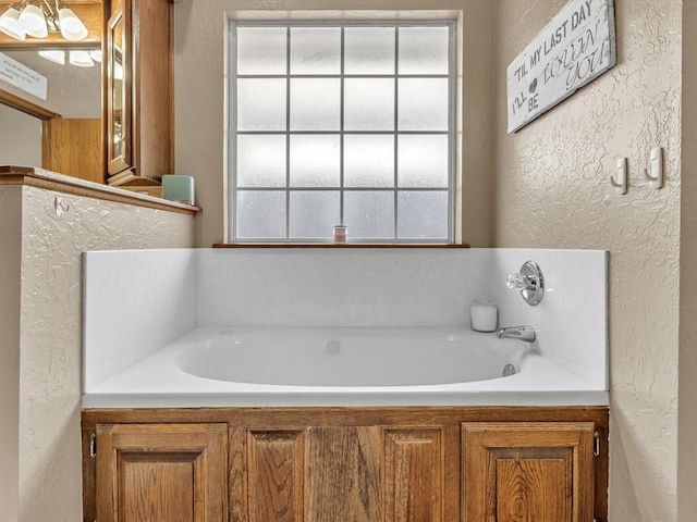 full bathroom with a textured wall and a bath