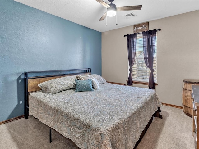 bedroom featuring ceiling fan, carpet flooring, visible vents, and baseboards