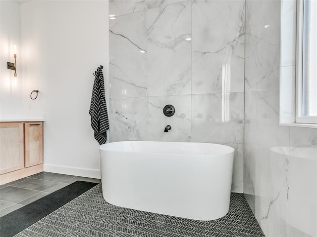 bathroom featuring tile patterned floors, a bathtub, and vanity