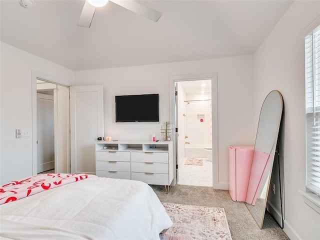 carpeted bedroom with ceiling fan and ensuite bath