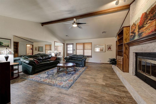 living room featuring a brick fireplace, vaulted ceiling with beams, and ceiling fan