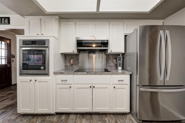 kitchen featuring white cabinetry, decorative backsplash, dark hardwood / wood-style flooring, and stainless steel appliances