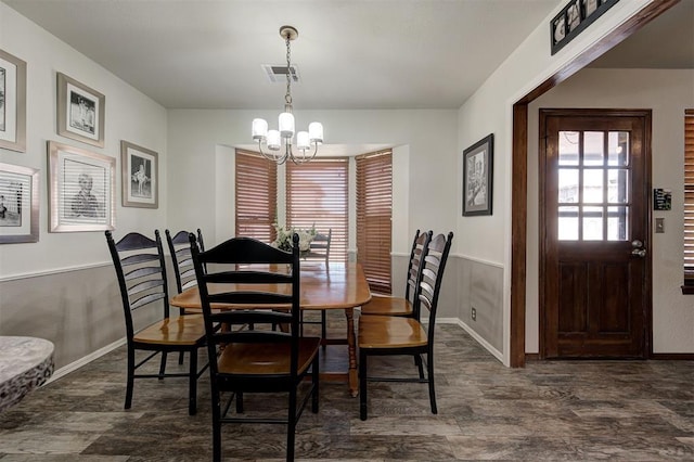 dining space with an inviting chandelier and dark hardwood / wood-style flooring