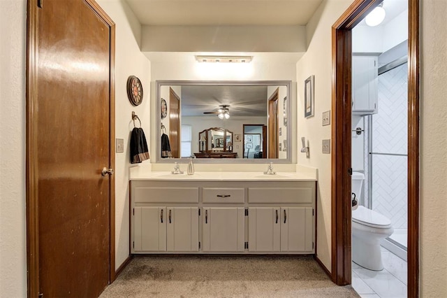 bathroom with vanity, toilet, and ceiling fan