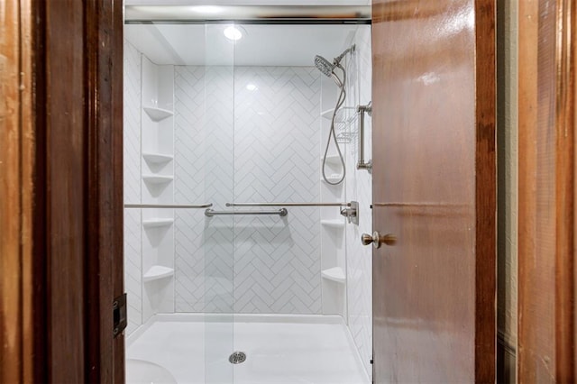 bathroom featuring a shower with shower door