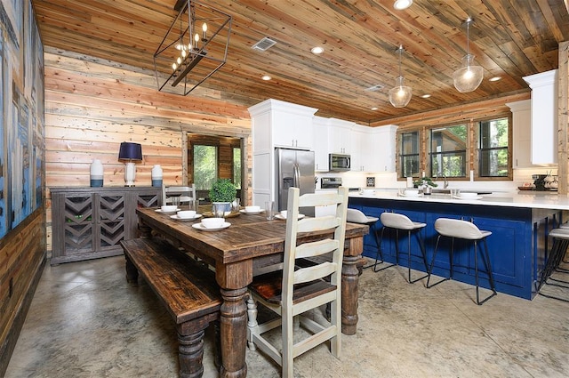 dining area featuring finished concrete flooring, wooden ceiling, visible vents, and recessed lighting