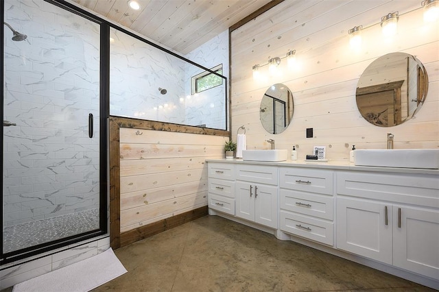 bathroom featuring wood walls, a sink, a shower stall, and double vanity