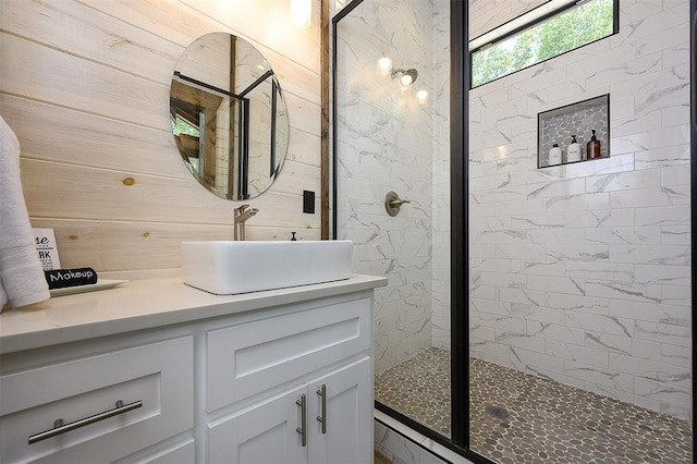 full bath with wood walls, a shower stall, and vanity