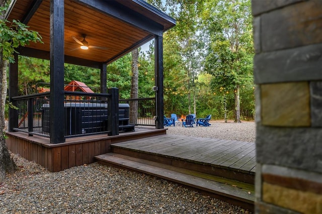 deck featuring an outdoor fire pit and ceiling fan