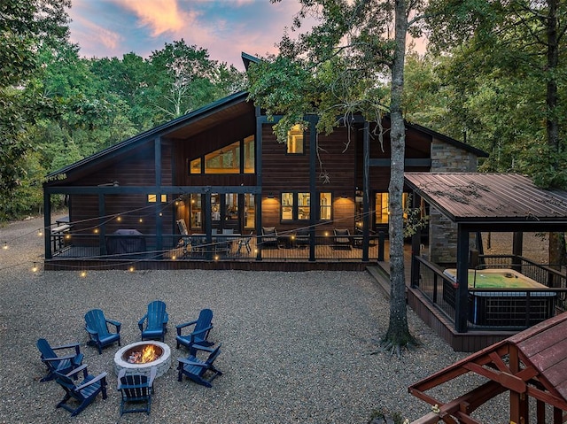 65 Rocky Rose Cir, Broken Bow, OK 74728 - rear view of house with a fire pit