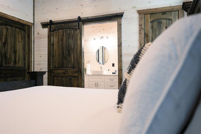 65 Rocky Rose Cir, Broken Bow, OK 74728 - bedroom featuring wooden walls and ensuite bathroom
