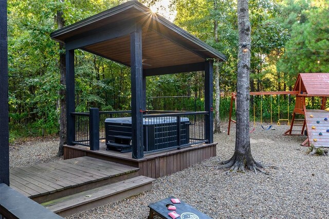 65 Rocky Rose Cir, Broken Bow, OK 74728 - deck featuring a playground, a hot tub, a gazebo, and central AC