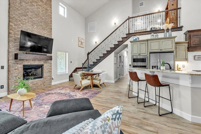 living room with a fireplace and light hardwood / wood-style flooring