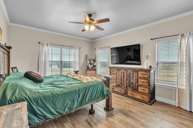 bedroom with ornamental molding, ceiling fan, and light hardwood / wood-style floors