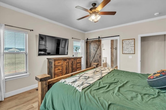 bedroom with connected bathroom, ceiling fan, crown molding, a barn door, and light hardwood / wood-style flooring