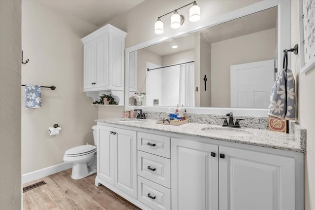 bathroom with vanity, a shower with curtain, wood-type flooring, and toilet