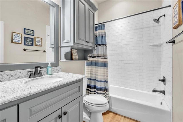 full bathroom with shower / bath combination with curtain, vanity, toilet, and wood-type flooring