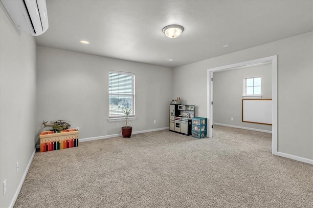 rec room featuring an AC wall unit and light colored carpet