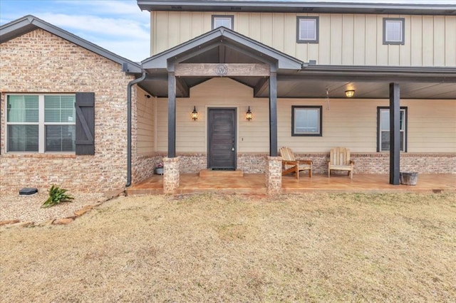 view of front of home with a front yard and a patio