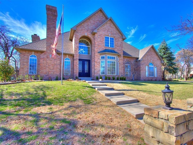 view of front facade featuring a front lawn and french doors