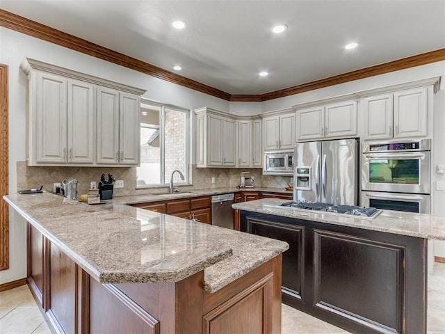 kitchen featuring light tile patterned flooring, a kitchen island, appliances with stainless steel finishes, sink, and light stone counters