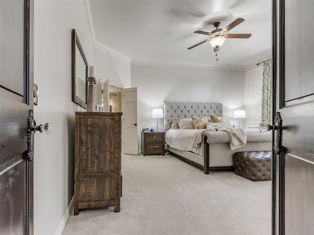 carpeted bedroom with ornamental molding and ceiling fan