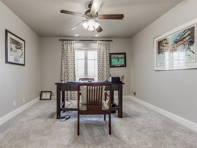 office space featuring ceiling fan and light colored carpet