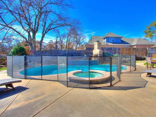 view of pool with an in ground hot tub and a patio