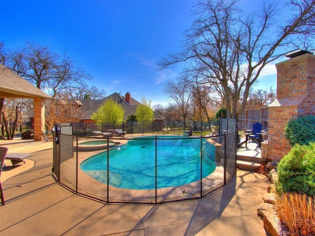 view of swimming pool with an in ground hot tub and a patio