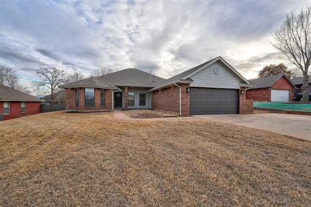 ranch-style house featuring a garage and a front yard