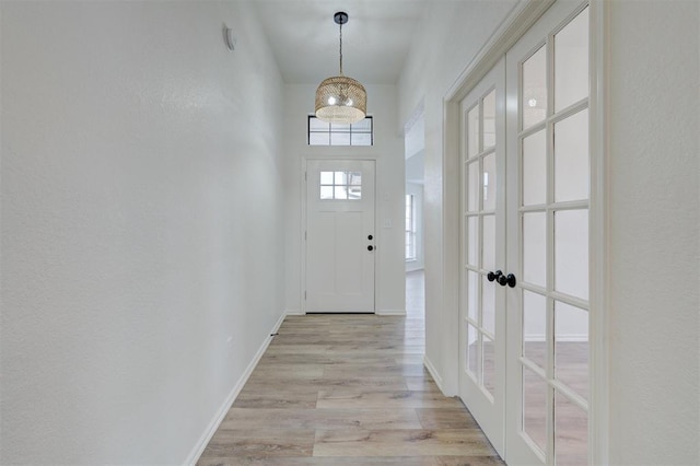 doorway featuring french doors and light wood-type flooring