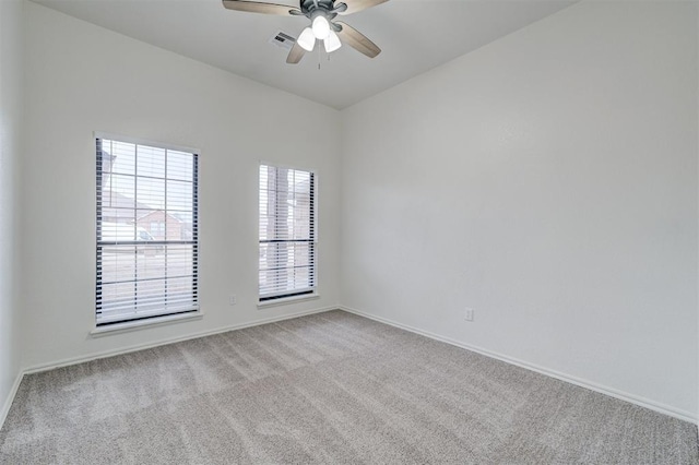 carpeted empty room featuring ceiling fan and a healthy amount of sunlight