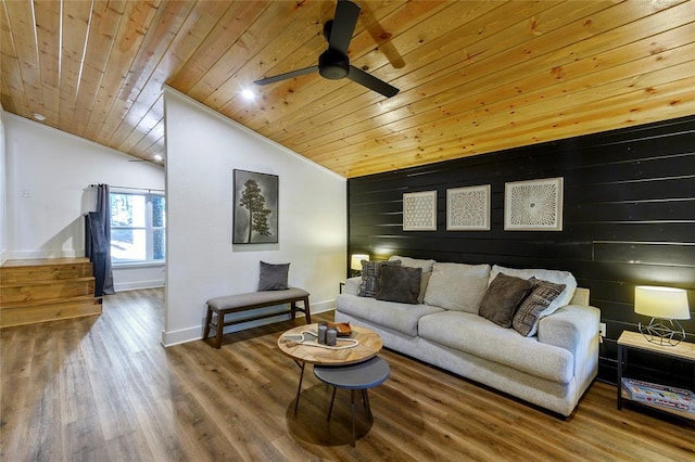 living room with lofted ceiling, wooden walls, hardwood / wood-style floors, and wooden ceiling