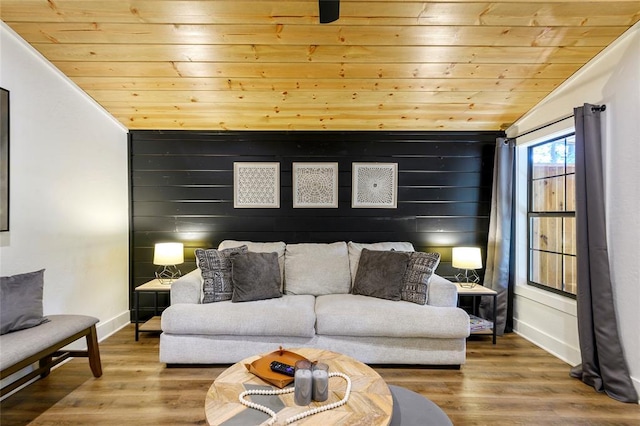 living room featuring hardwood / wood-style floors, wood ceiling, wooden walls, and vaulted ceiling