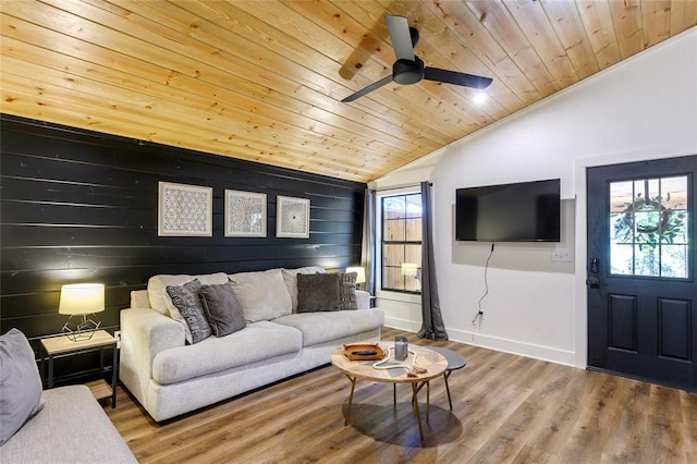 living room featuring wooden ceiling, vaulted ceiling, and wood walls