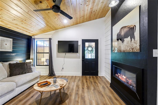 living room featuring wood ceiling, plenty of natural light, and vaulted ceiling