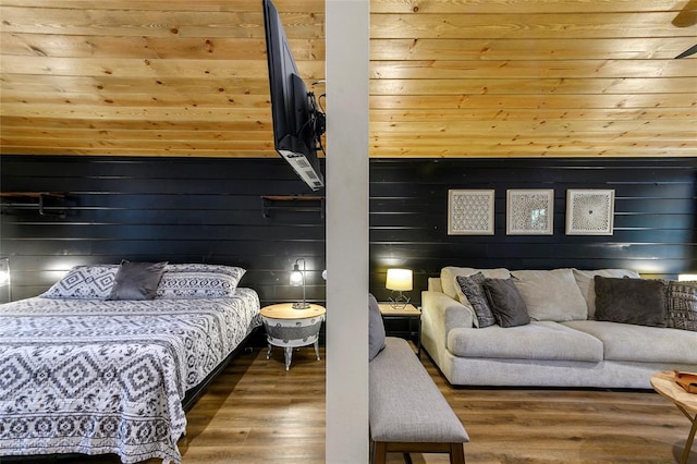 bedroom with dark wood-type flooring and wood walls